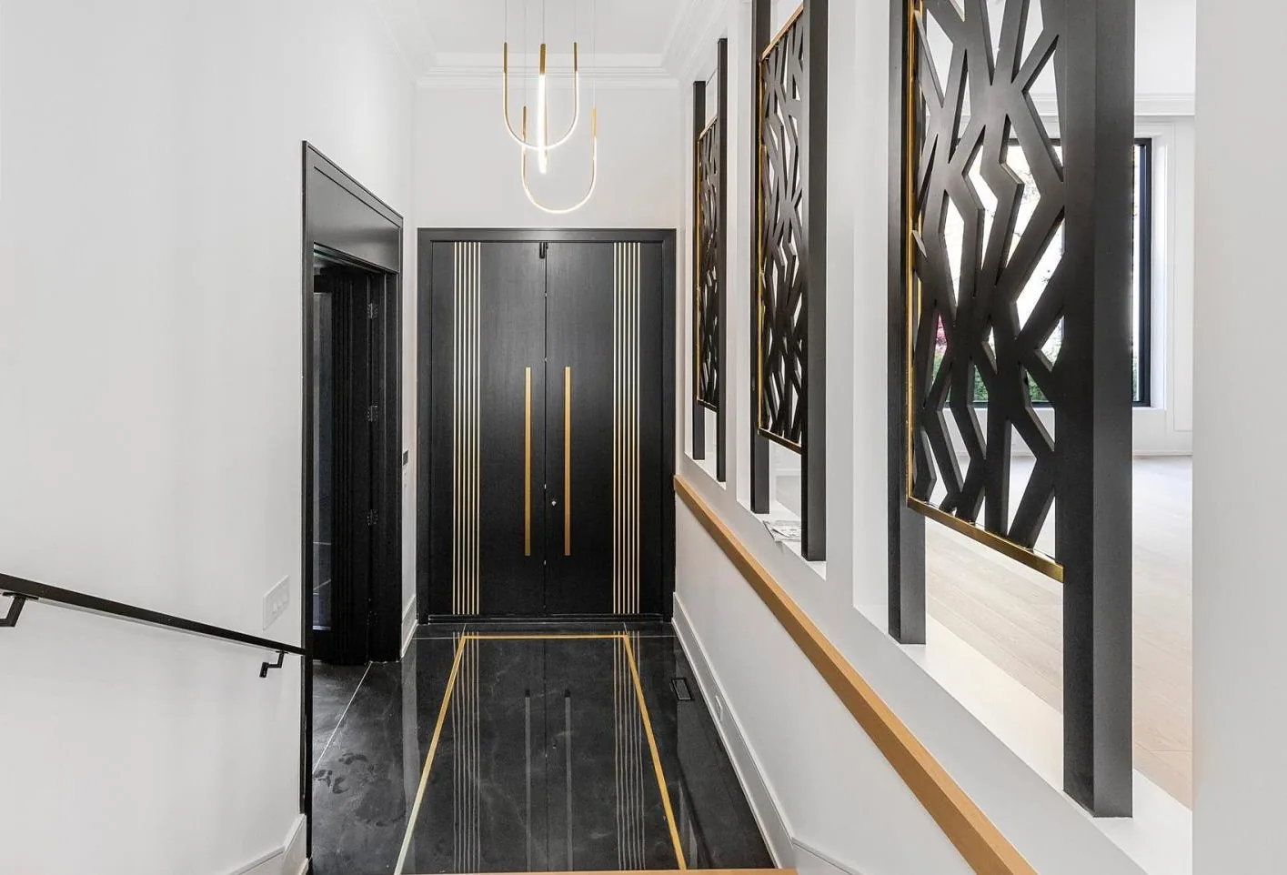 Kaizen Construction Group — premium custom interior hallway with gold millwork