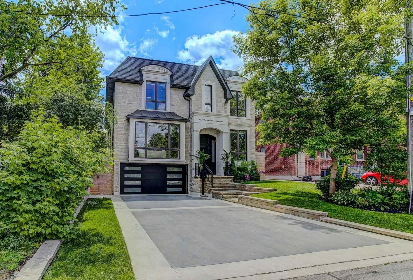 Kaizen 2000 Construction — custom home exterior with deck and landscaped backyard