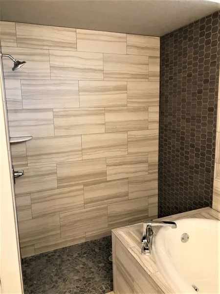 Owner's ensuite with tiled walk-in shower and tub