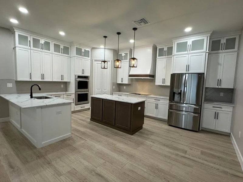 Custom kitchen with stone island and built-in appliances